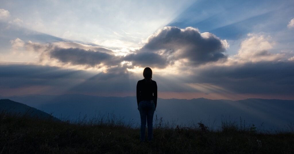 Christian Blog feature image - Heavenly Reputation - Heavenly Skies in front of person standing